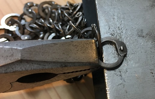 ready to hammer the rivet into the stainless steel chainmail ring