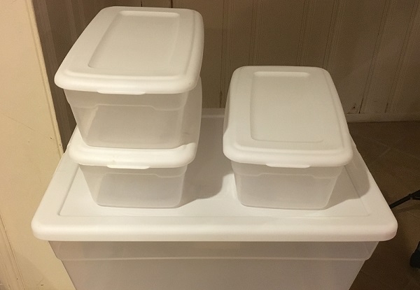 Plastic storage bins for storing tabletop terrain pieces.