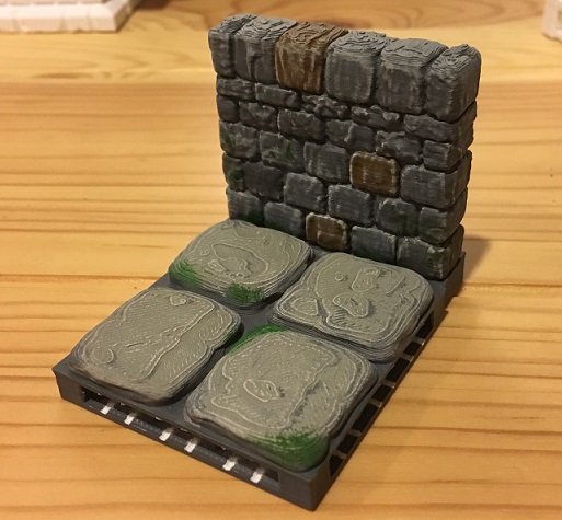 Some green moss details on a 3D printed dungeon tile and wall.
