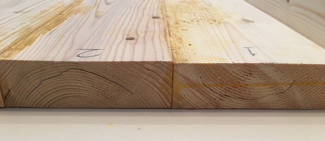 Close up showing the alternating direction of growth rings on a table top