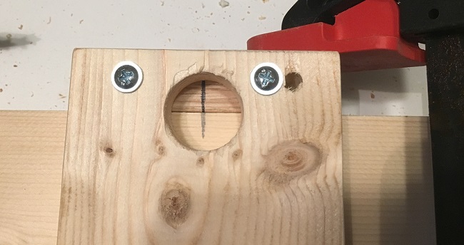 Doweling jig clamped onto the edge of a board